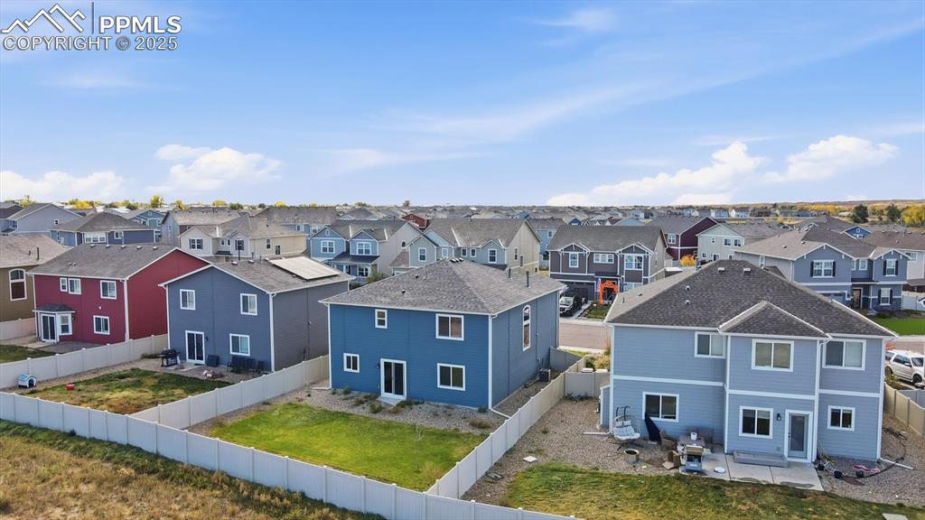 Image 32 of 36: Aerial view of home and fenced backyard.