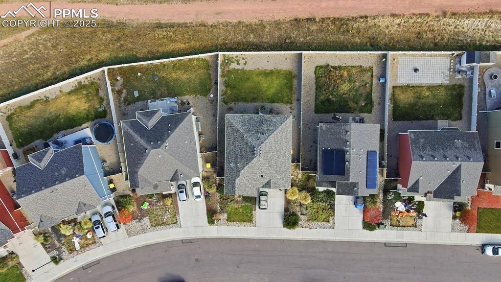Image 33 of 36: Aerial view of front and backyard of home that backs on to a walking trail.