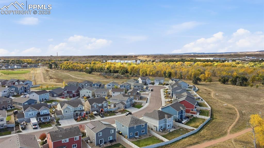 Image 34 of 36: view of the open space and walking trails behind the home.