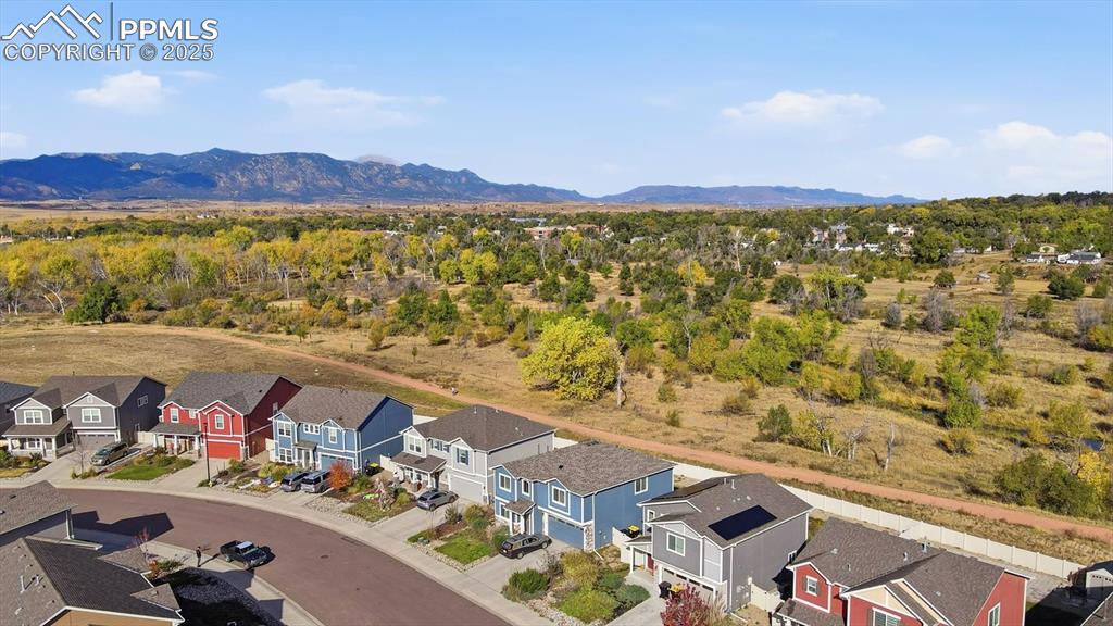 Image 4 of 36: Aerial views of home, open space with trails, and beautiful mountain views.