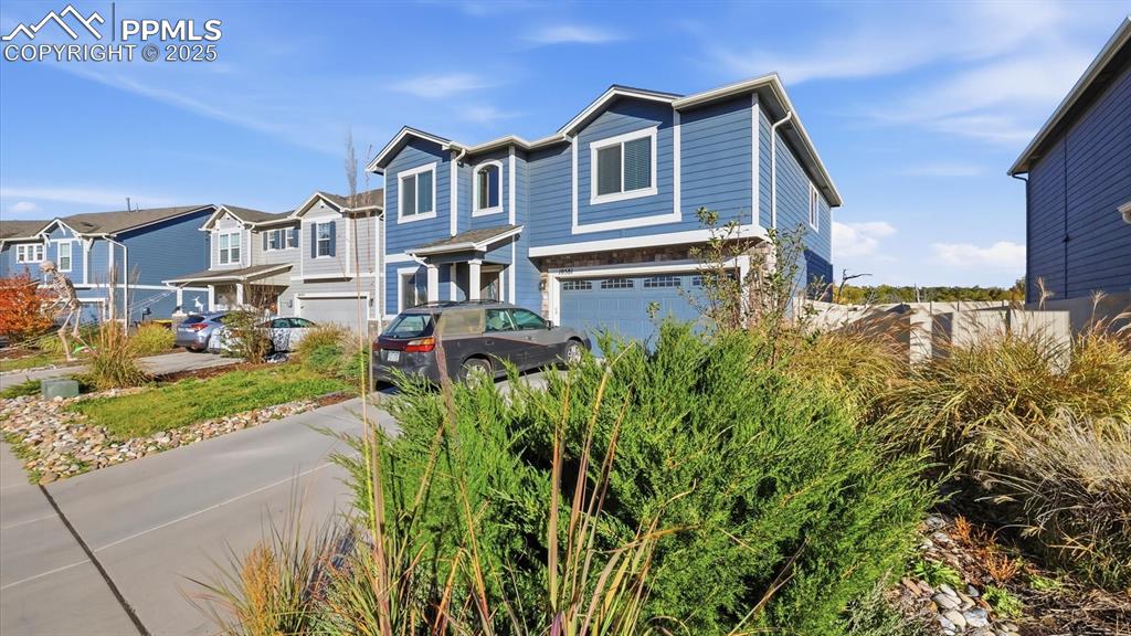 Image 6 of 36: Front view of home and side yard.