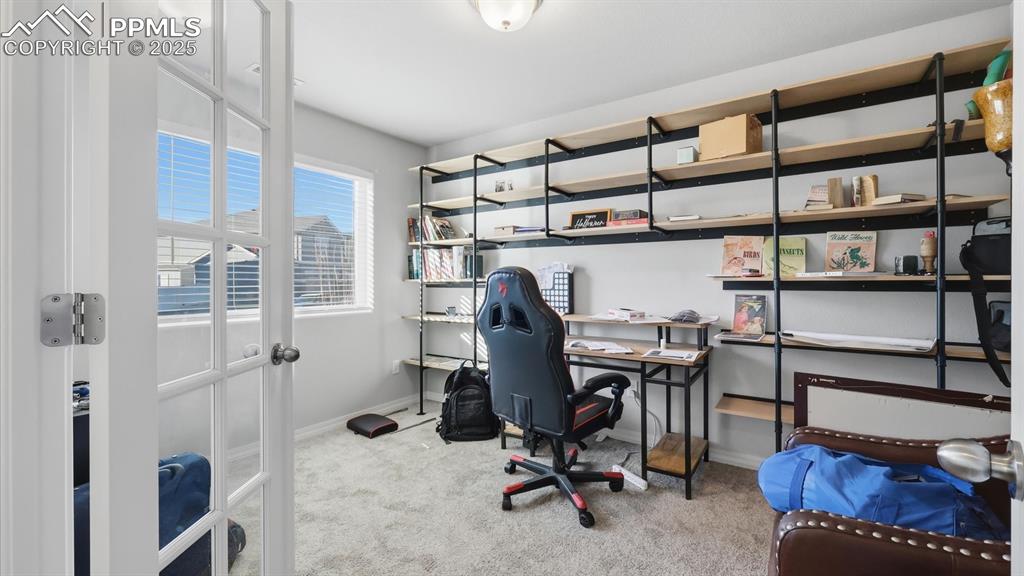 Image 9 of 36: Main level Office with built-in bookshelves.