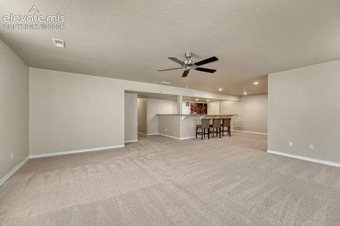Image 22 of 42: Family room in basement with plenty of space for a Big Screen TV! New canne