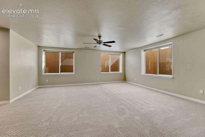 Image 37 of 42: Huge Basement Family room with large windows and fan