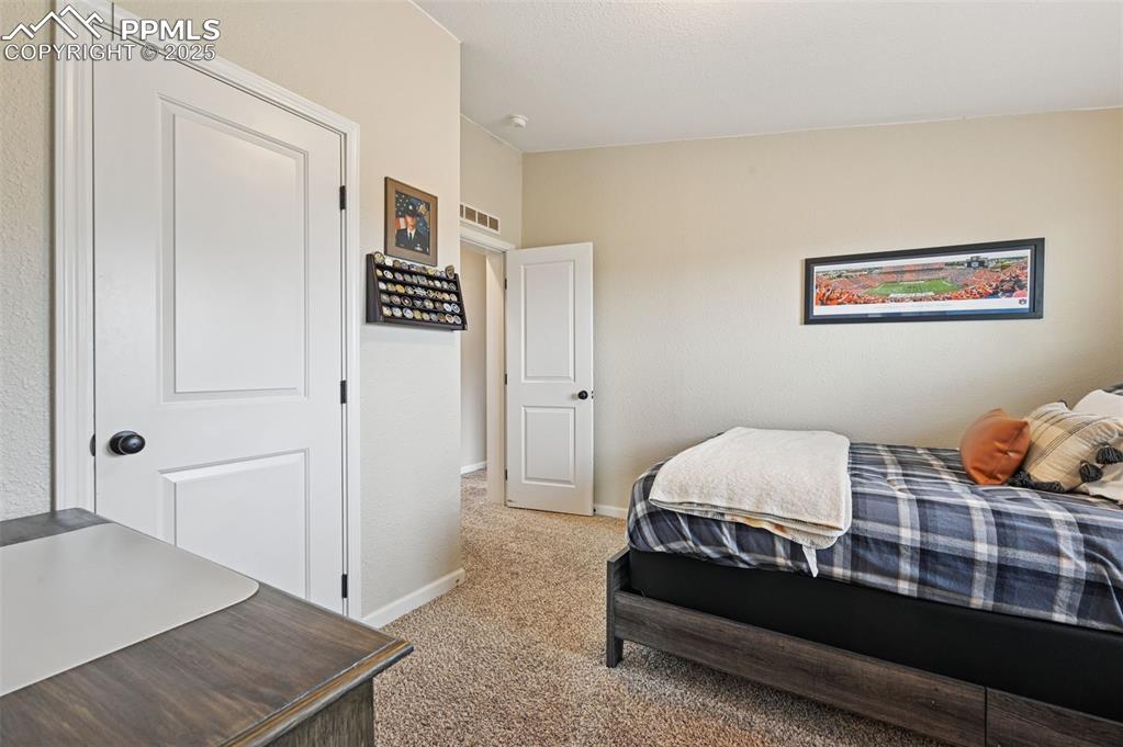 Image 14 of 31: Bedroom with light carpet and baseboards