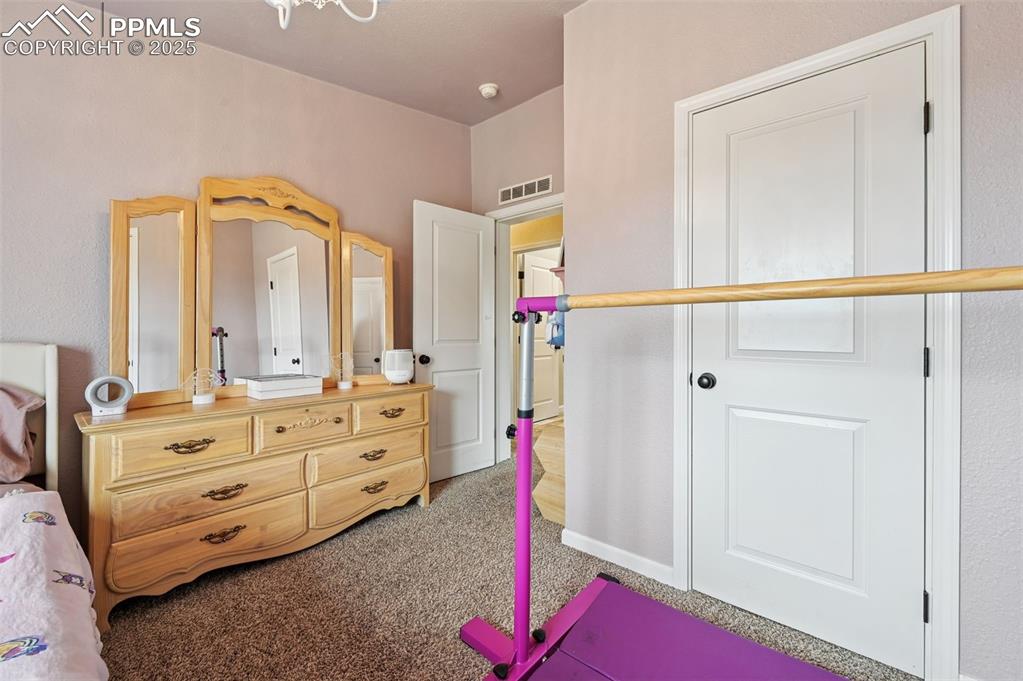 Image 17 of 31: Bedroom with light colored carpet and baseboards