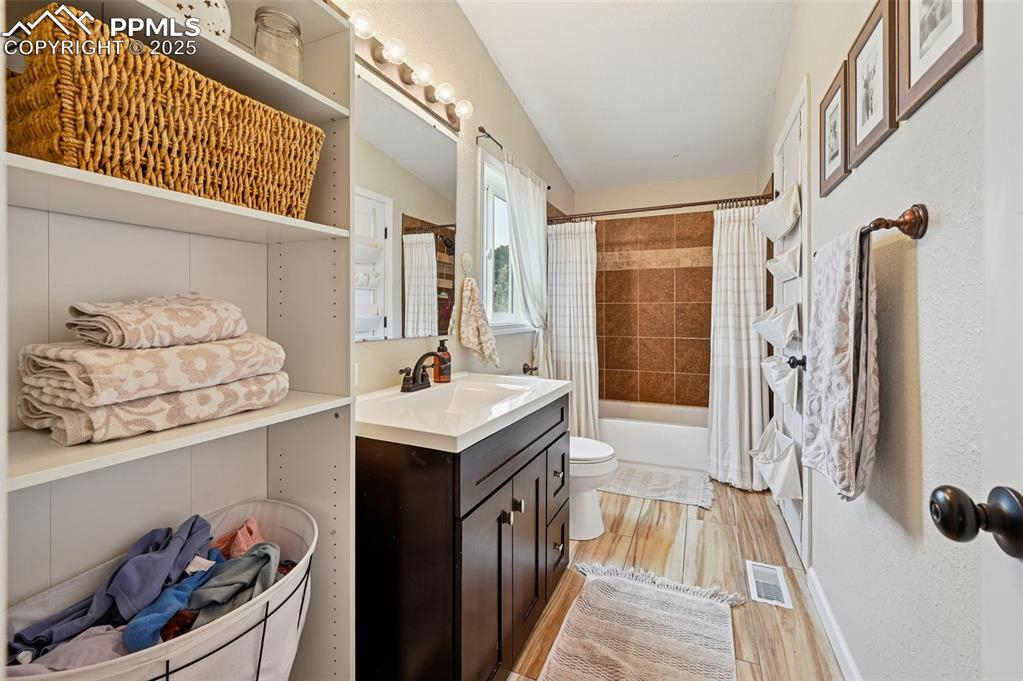 Image 18 of 31: Full bath featuring vanity, light wood-type flooring, and shower / bathtub 