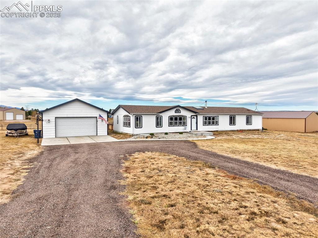 Image 2 of 31: Ranch-style house with an outbuilding and a detached garage