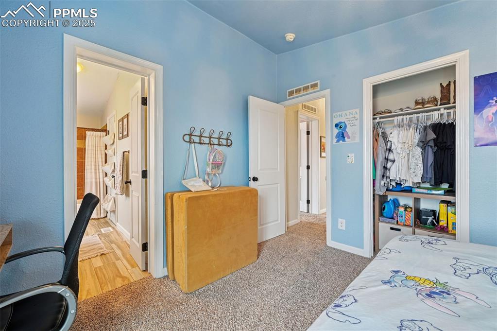 Image 20 of 31: Bedroom featuring a closet and light colored carpet