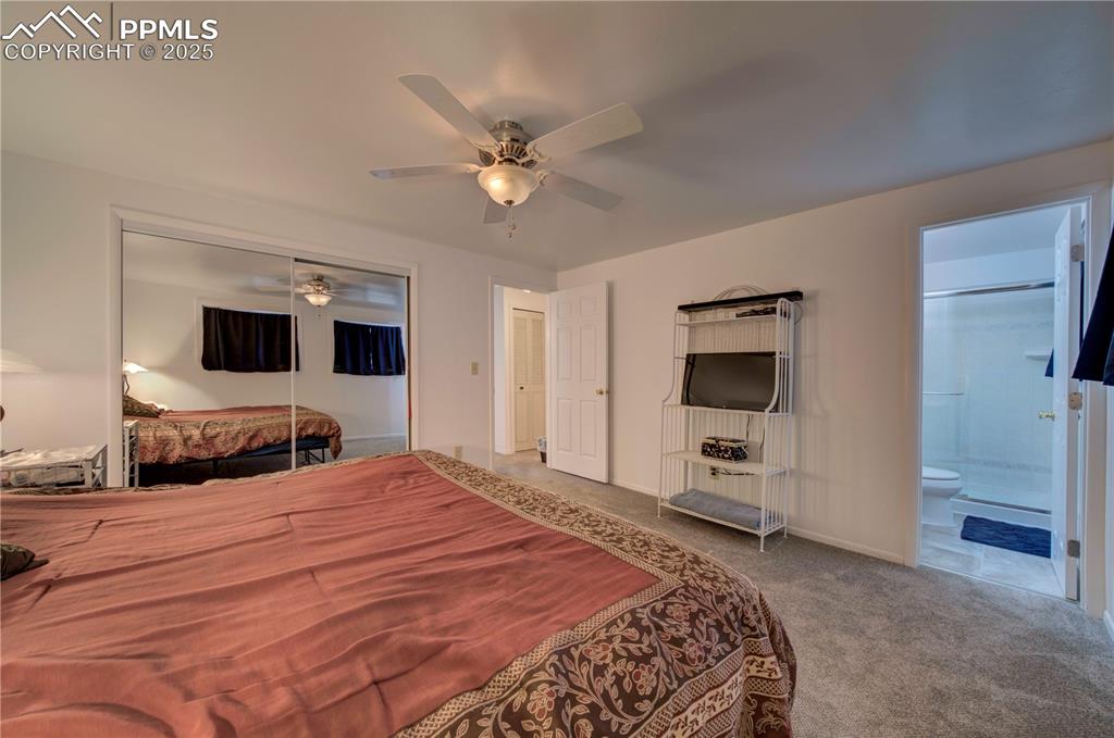 Image 19 of 50: Bedroom featuring a closet, a ceiling fan, carpet flooring, and ensuite bat