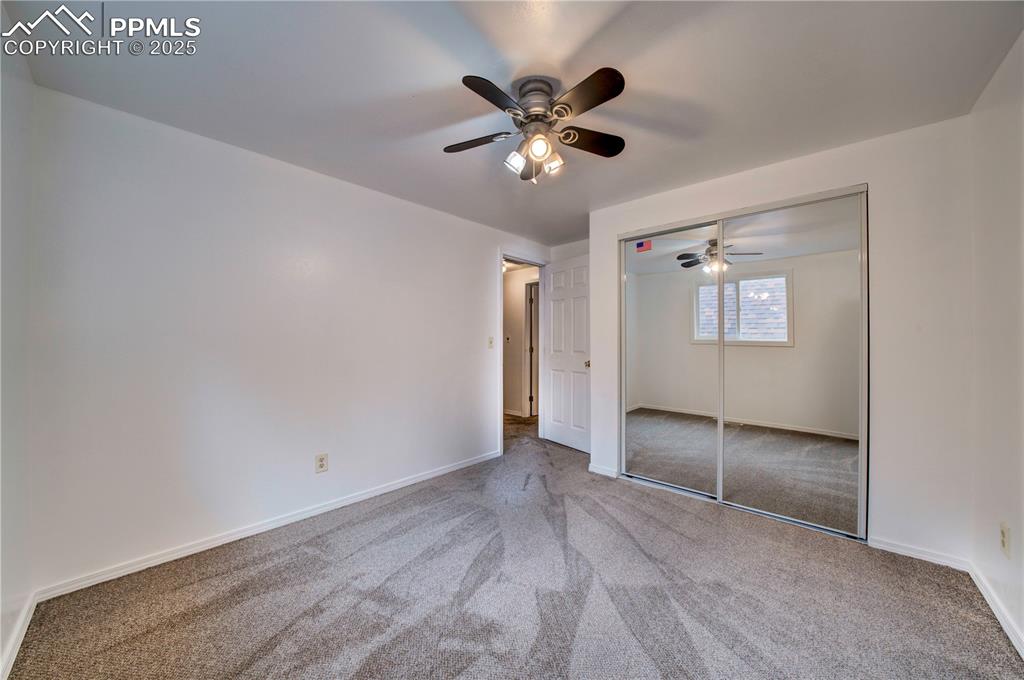 Image 20 of 50: Unfurnished bedroom featuring carpet floors, a ceiling fan, and a closet