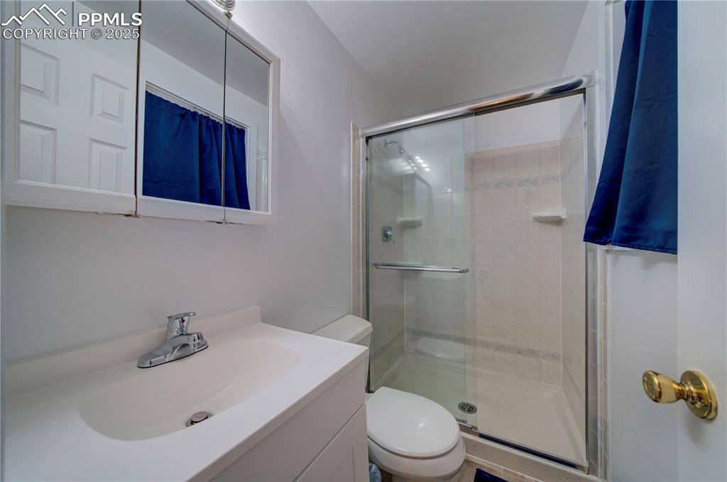 Image 23 of 50: Bathroom featuring a stall shower and vanity