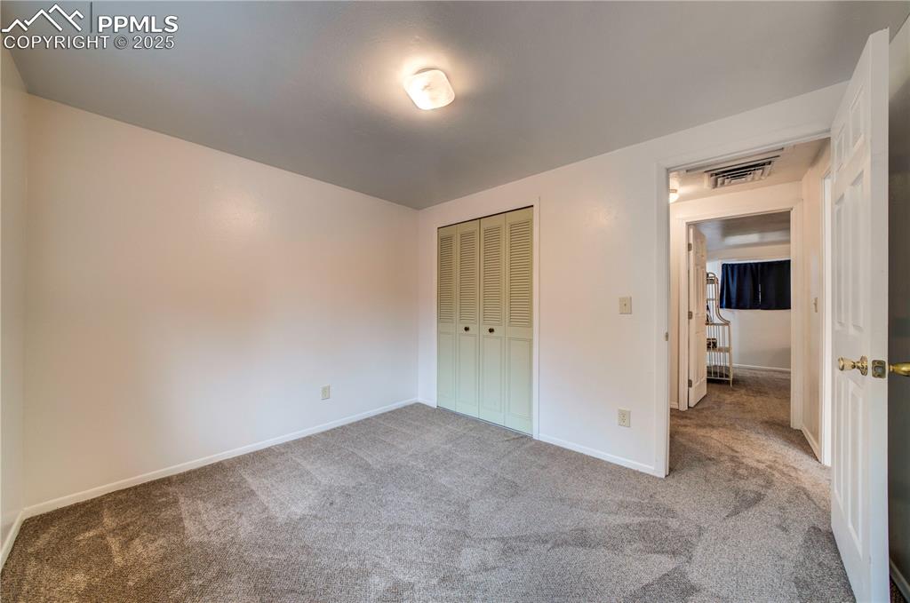 Image 38 of 50: Unfurnished bedroom with carpet and a closet