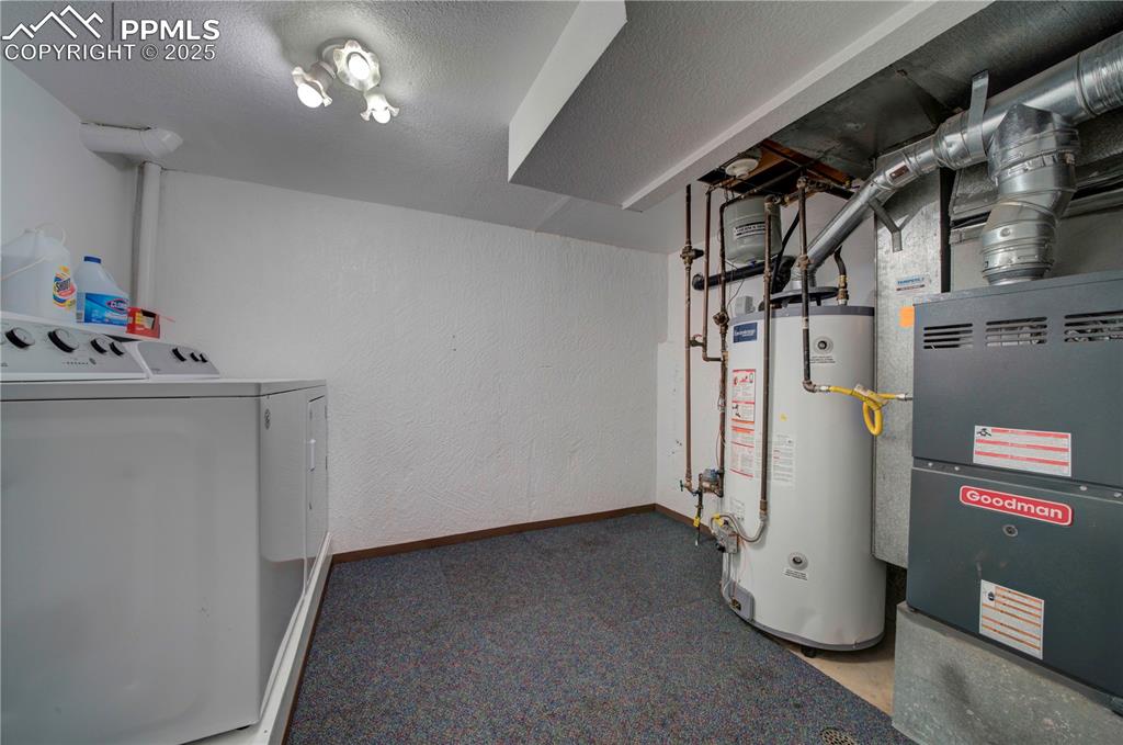 Image 40 of 50: Utilities featuring water heater, separate washer and dryer, and heating un