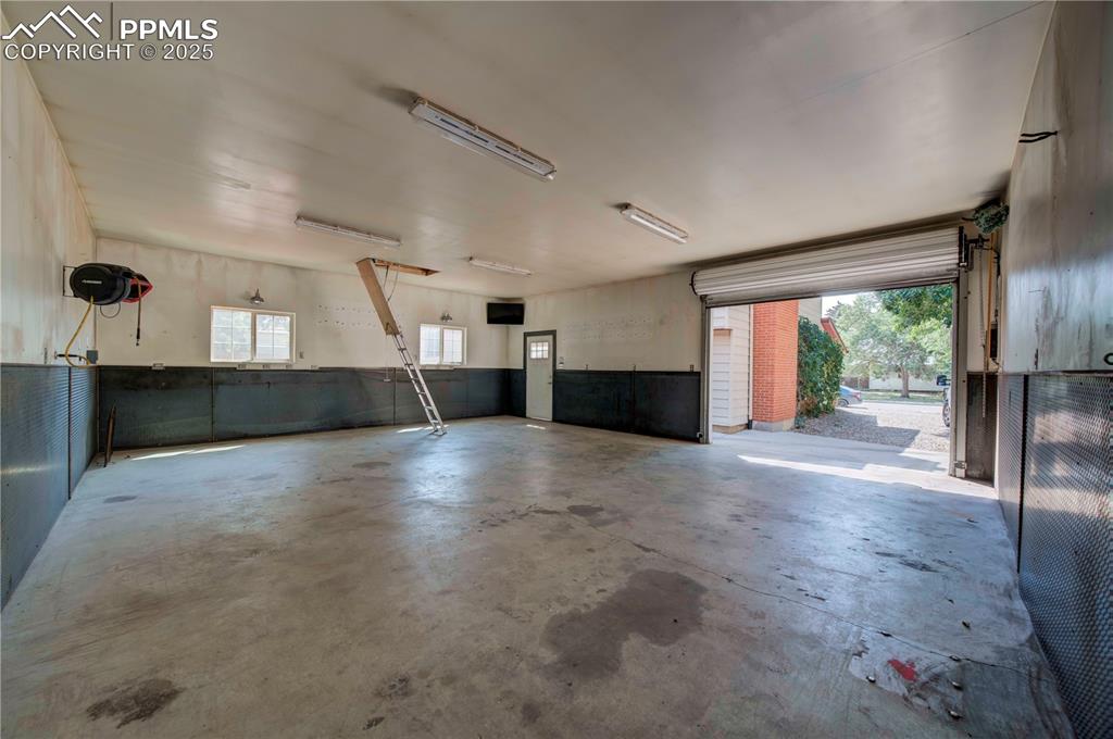 Image 42 of 50: Garage with a wainscoted wall