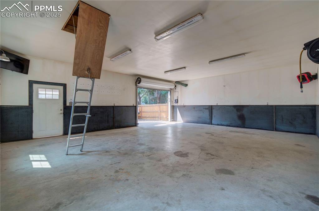 Image 43 of 50: Garage with a wainscoted wall