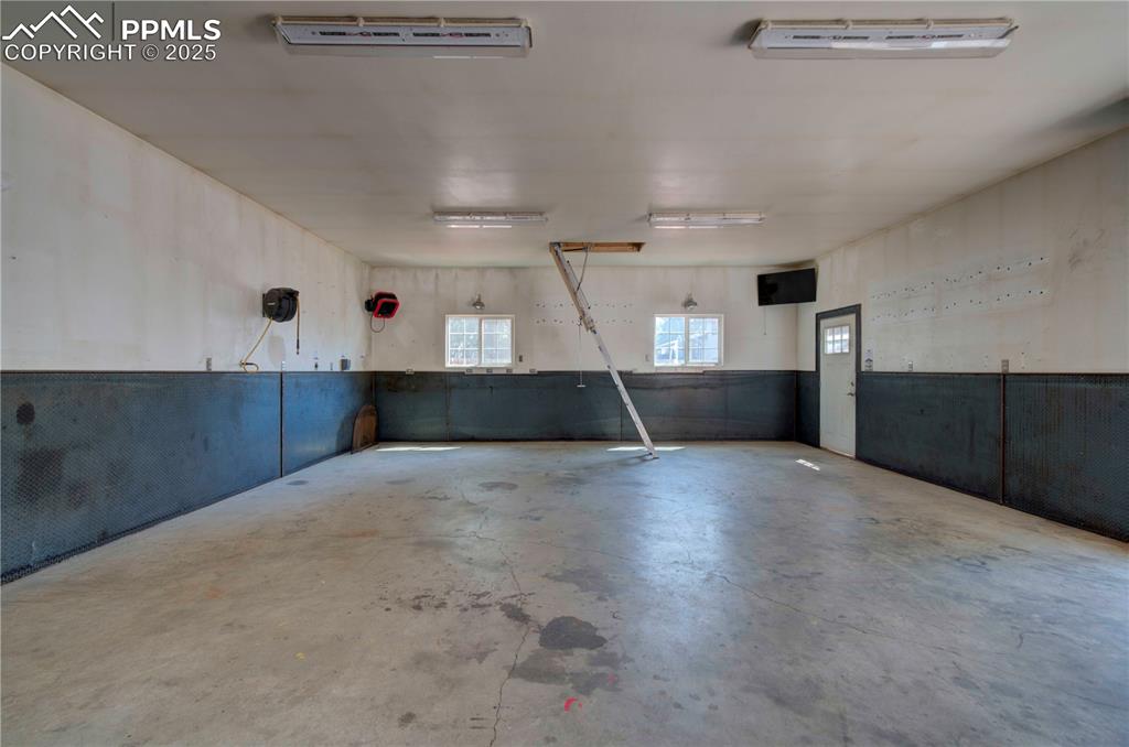 Image 45 of 50: Garage featuring wainscoting