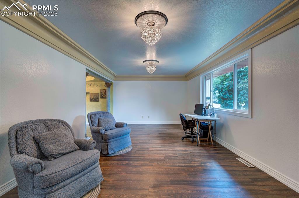 Image 6 of 50: Office featuring dark wood-style flooring, a textured ceiling, crown moldin