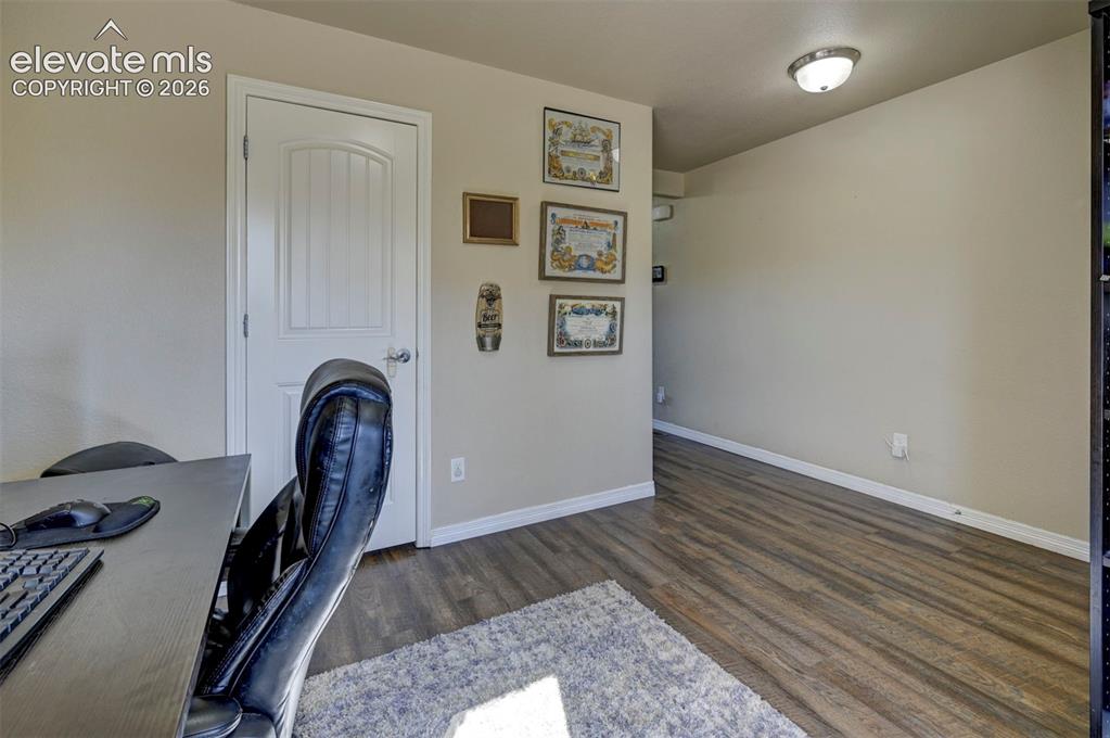 Image 11 of 45: Wood-finish flooring with neutral wall tones and white trim