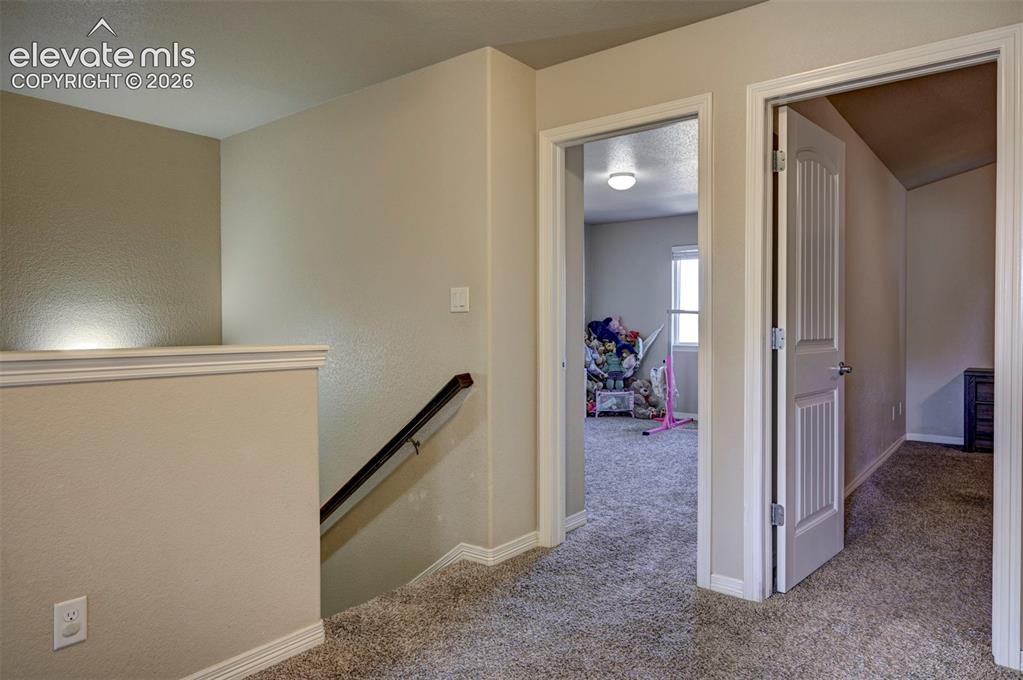 Image 22 of 45: Neutral wall color throughout, white trim, carpeted flooring, and white int