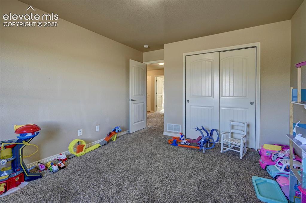 Image 24 of 45: Neutral wall paint, carpet flooring, interior door with brushed nickel hard