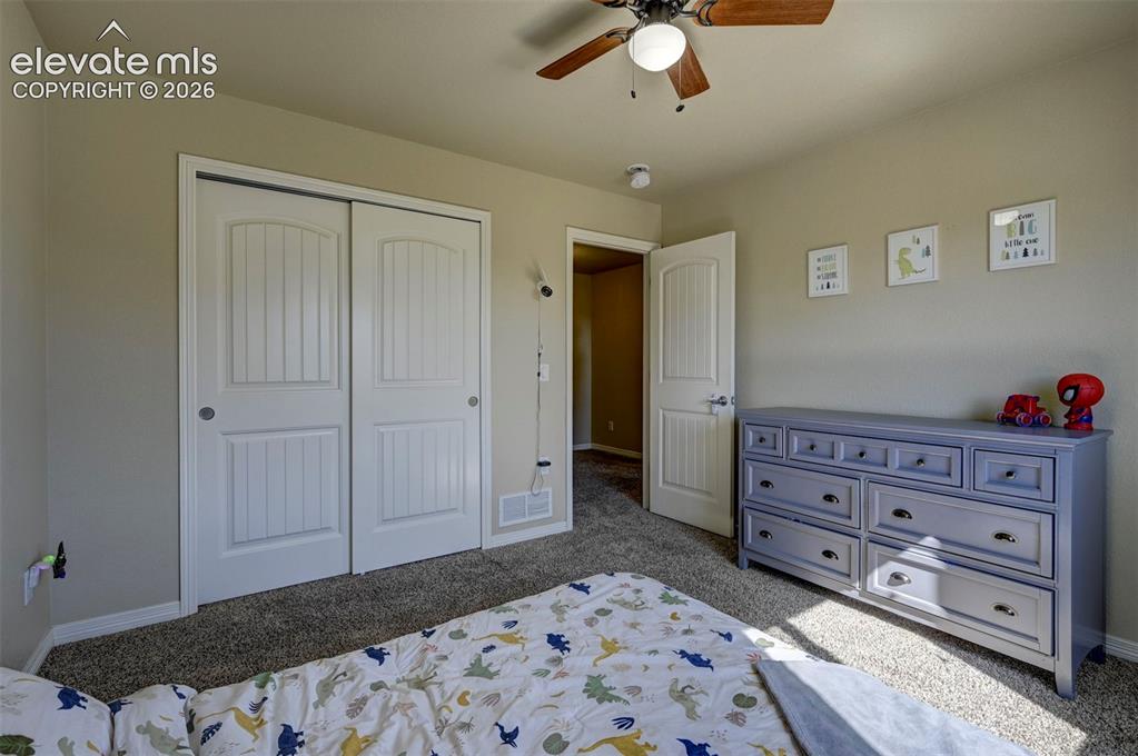Image 26 of 45: Neutral-toned walls, textured carpeting, white paneled doors, and a ceiling