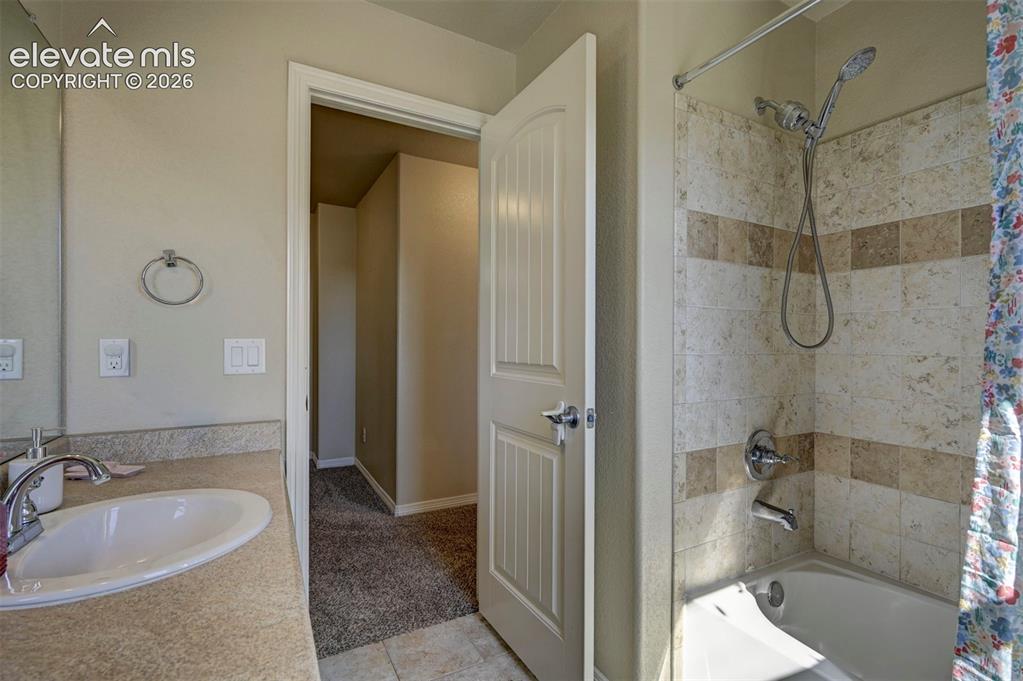 Image 28 of 45: Built-in vanity with an oval sink, polished chrome faucet, and integrated c
