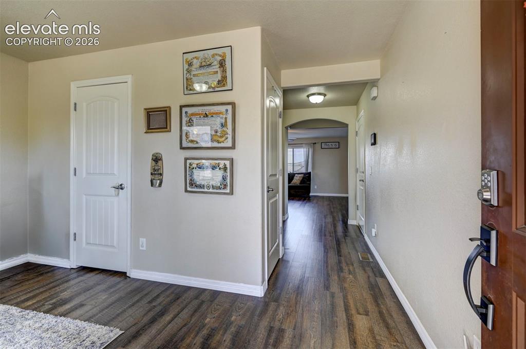 Image 9 of 45: Wood-finish flooring, white trim, and neutral wall tones