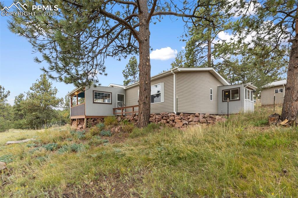 Image 2 of 37: View of front deck and the side entry with mud room.