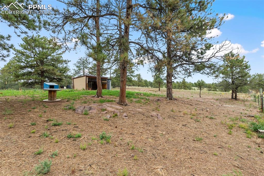 Image 34 of 37: View of yard with an outdoor structure and a view of rural / pastoral area