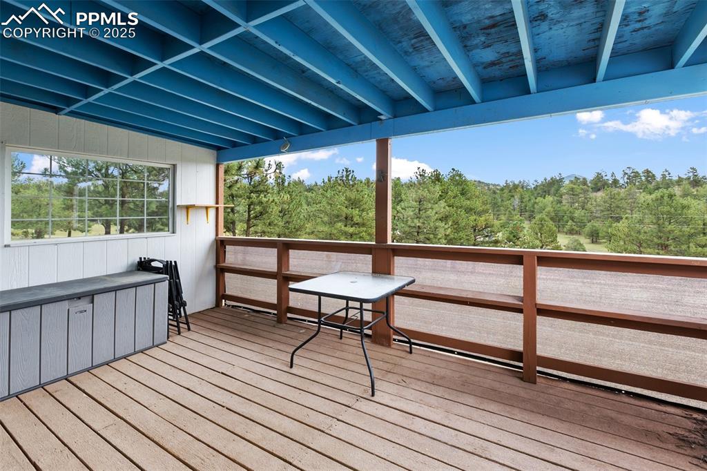Image 7 of 37: View of front covered wooden covered deck.