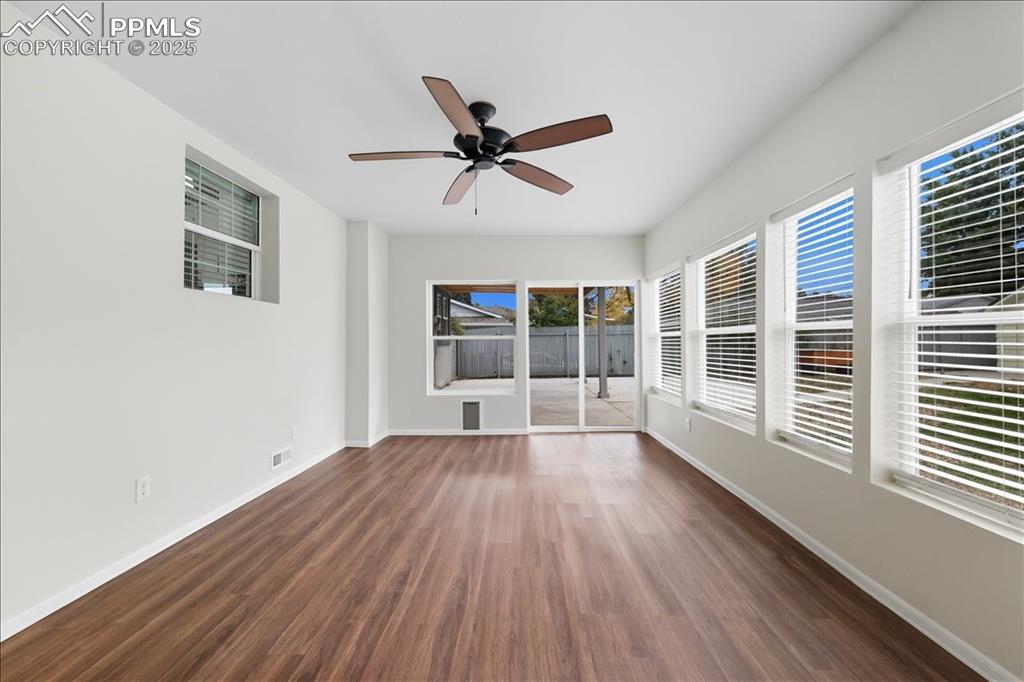 Image 11 of 22: Spare room with dark wood-type flooring and ceiling fan
