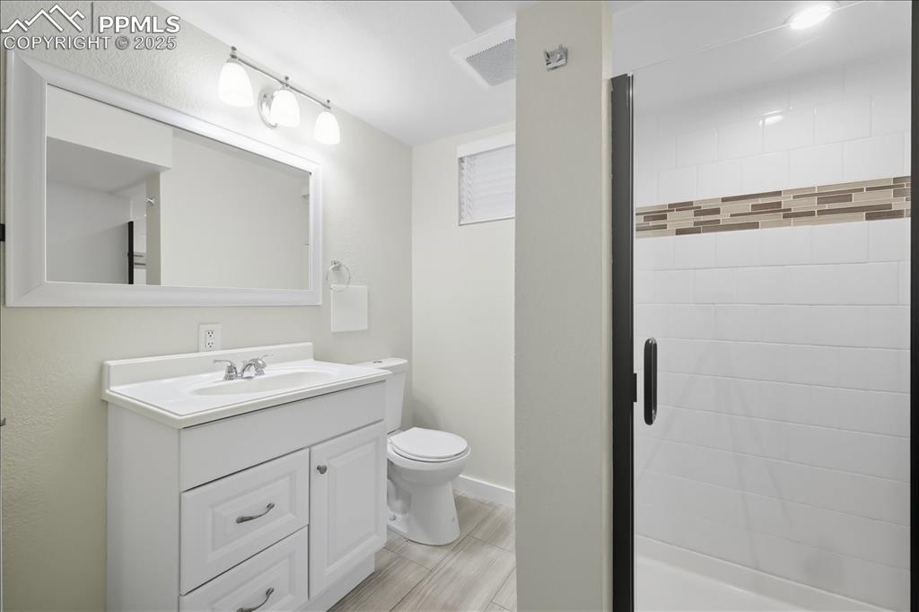 Image 14 of 22: Bathroom featuring vanity and a shower stall
