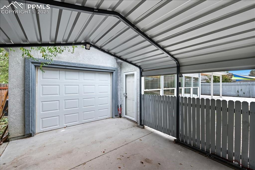 Image 17 of 22: Garage with drive through to carport