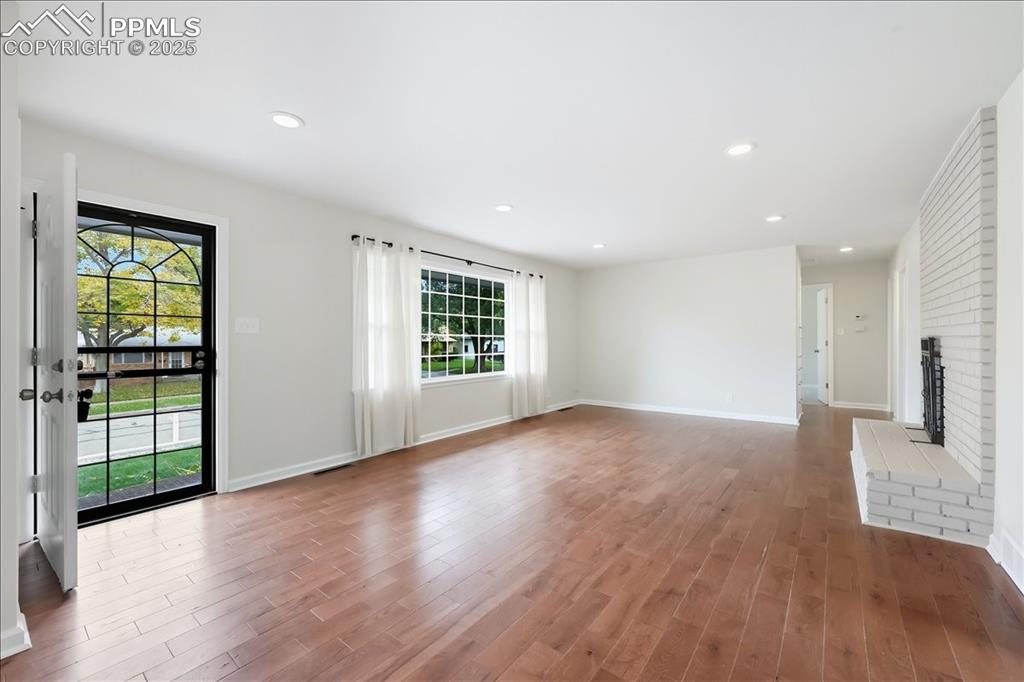 Image 3 of 22: Unfurnished living room recessed lighting, and a fireplace