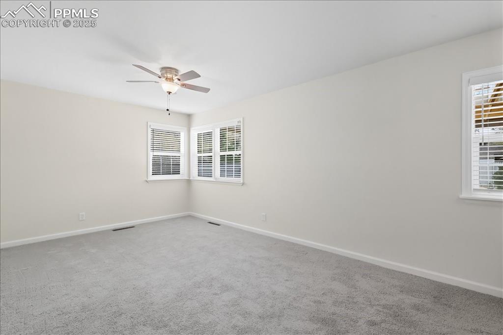 Image 5 of 22: Carpeted spare room with plenty of natural light and a ceiling fan