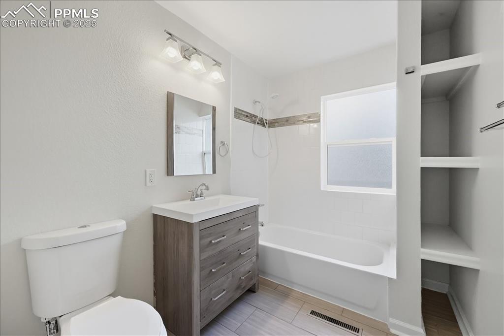 Image 7 of 22: Bathroom featuring vanity and shower / bath combination