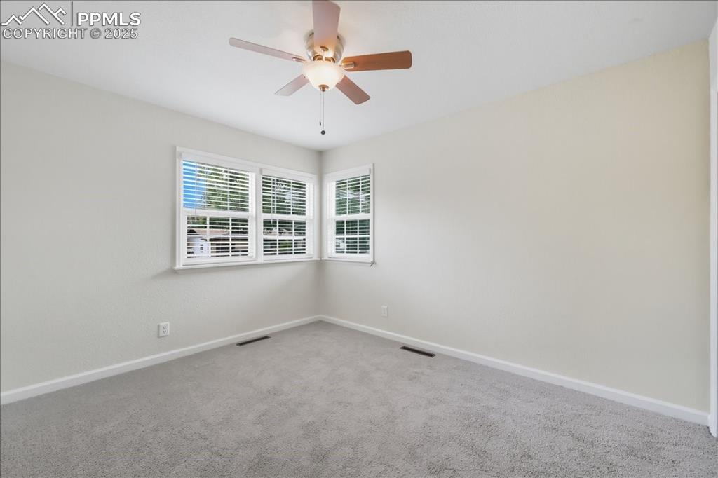Image 8 of 22: Spare room with carpet and a ceiling fan