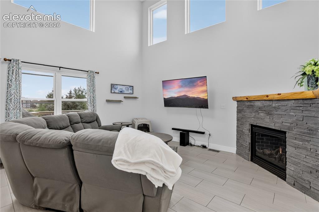 Image 12 of 29: Gas fireplace w/ stone surround & mantle