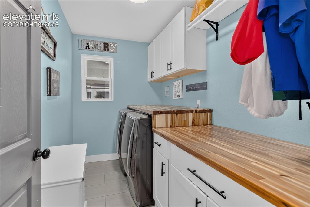Image 15 of 29: Laundry room w/ storage & folding counter