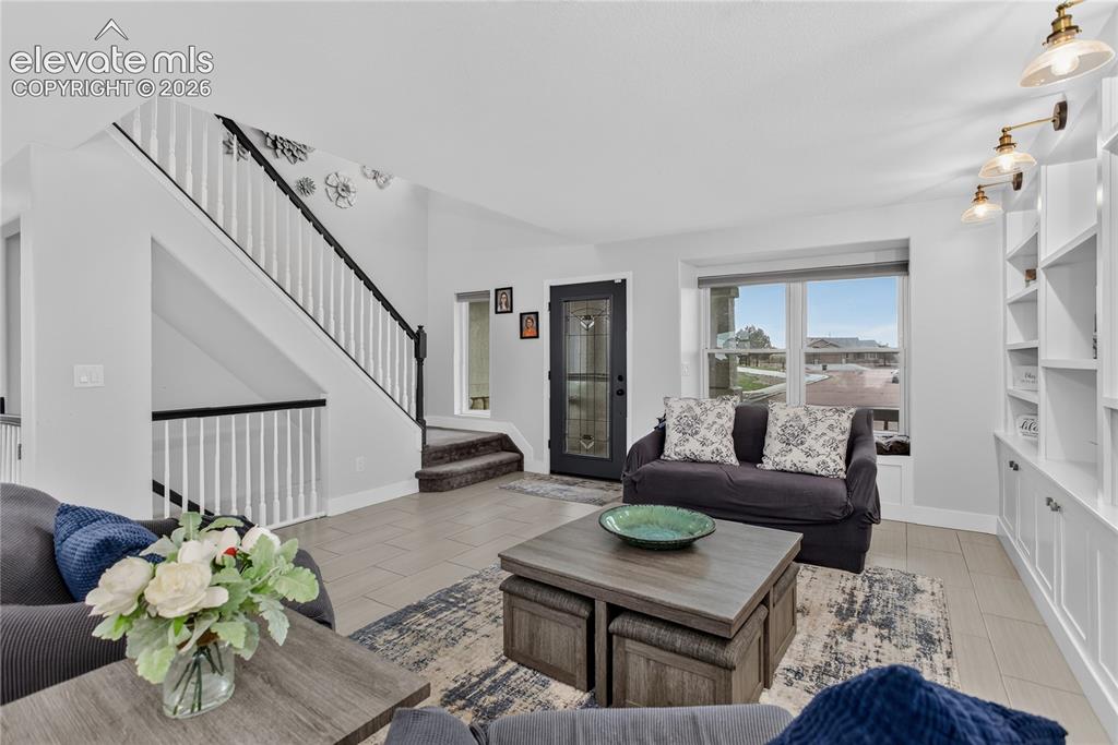 Image 3 of 29: Living room w/ built-in shelving