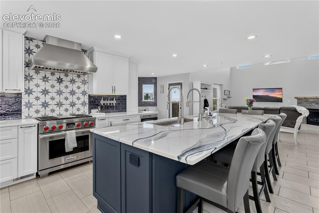 Image 7 of 29: Granite counters w/ undermount sink featuring dual faucets