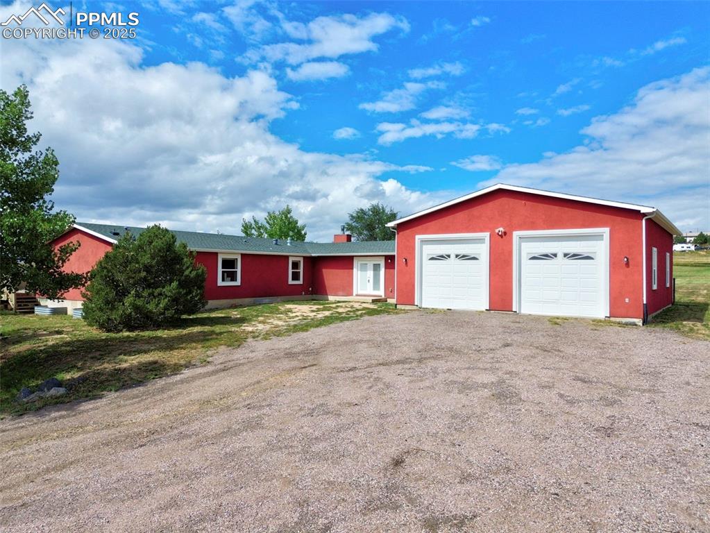 Image 2 of 50: Large oversized garage with electric and soaring ceilings