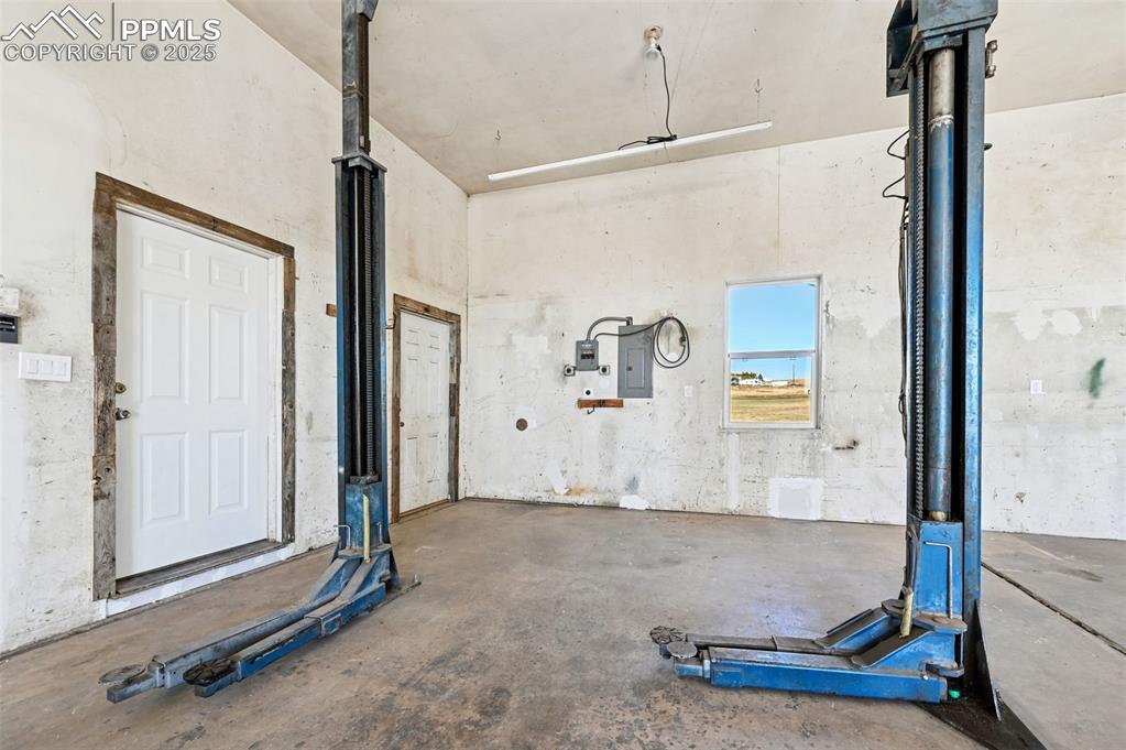 Image 38 of 50: Oversized attached garage with lift