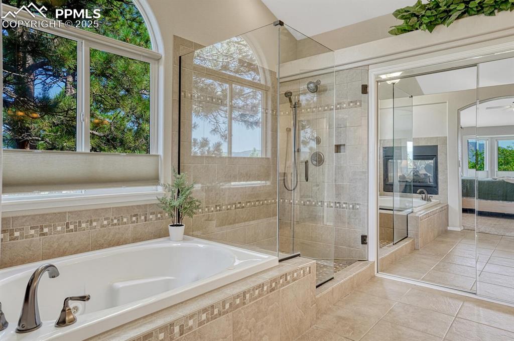 Image 28 of 48: Large soaking tub, updated shower and radiant heat floors