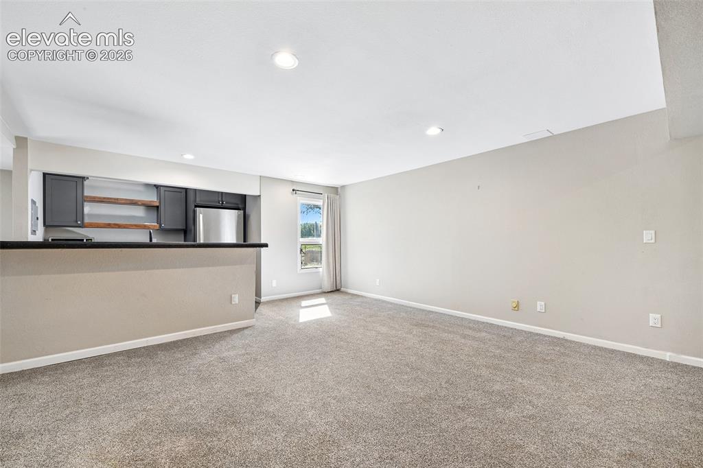 Image 33 of 46: Open-concept room featuring neutral wall paint, carpeting, recessed lightin