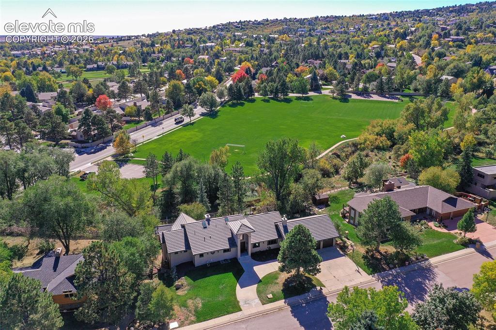 Image 41 of 46: Aerial perspective featuring a multi-gabled roofline, concrete driveway, at