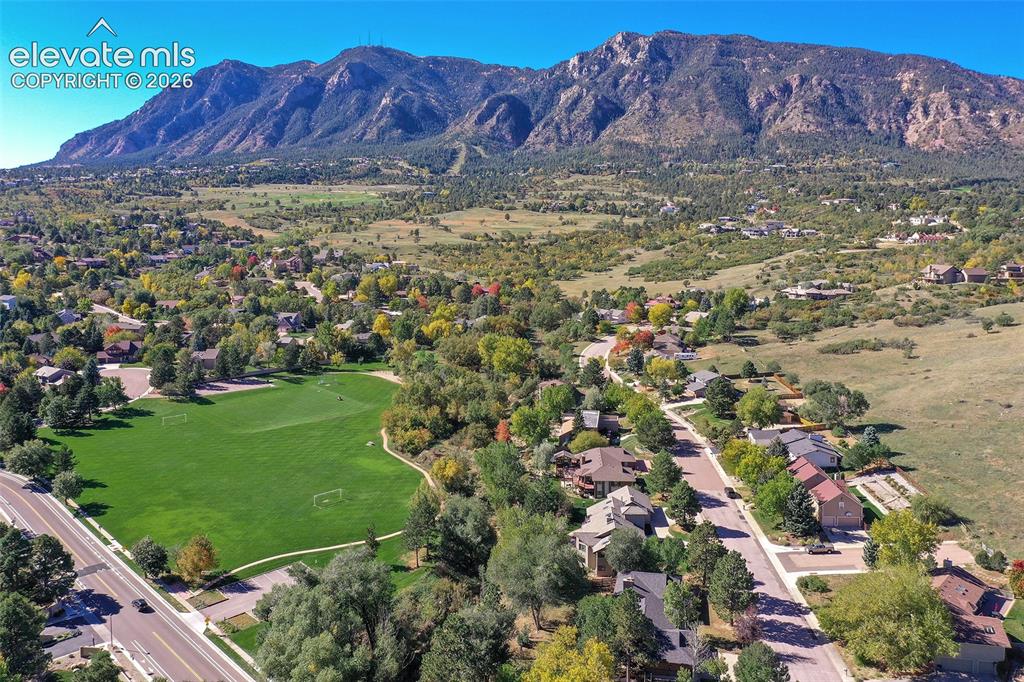 Image 42 of 46: Aerial perspective featuring mountainous topography, expansive open green s