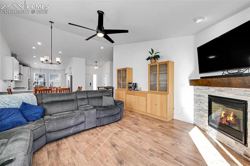 Image 13 of 29: Living room featuring light wood-style flooring, recessed lighting, a firep