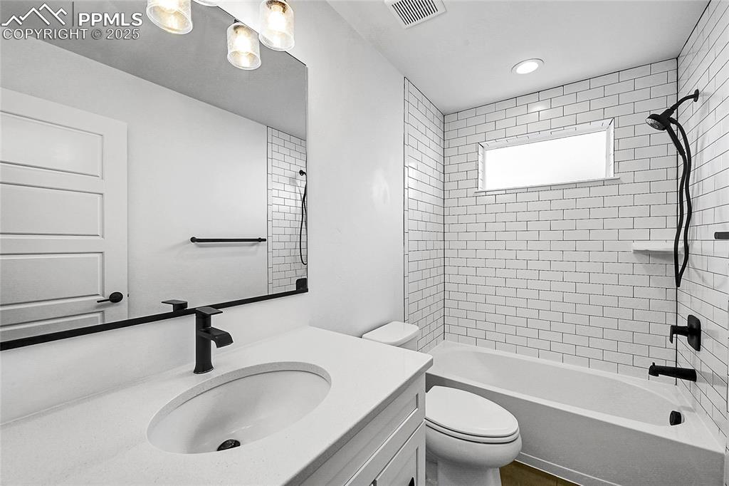 Image 15 of 29: Bathroom featuring shower / bathtub combination and vanity